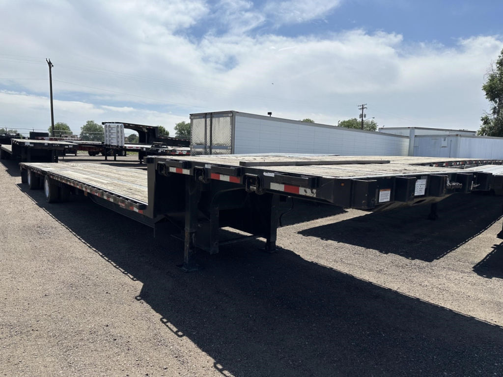 Great Dane spread air drop deck trailer showing flatbed with multiple decks and wiring, side railing, and undercarriage structure.