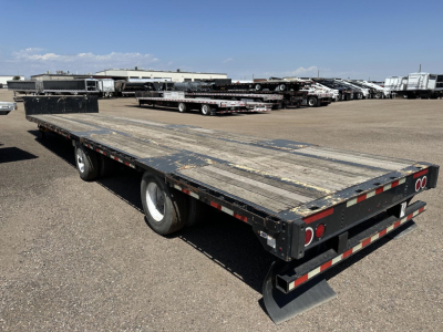 Great Dane spread air drop deck trailer shown from rear-left perspective with dual rear axles and wooden deck.