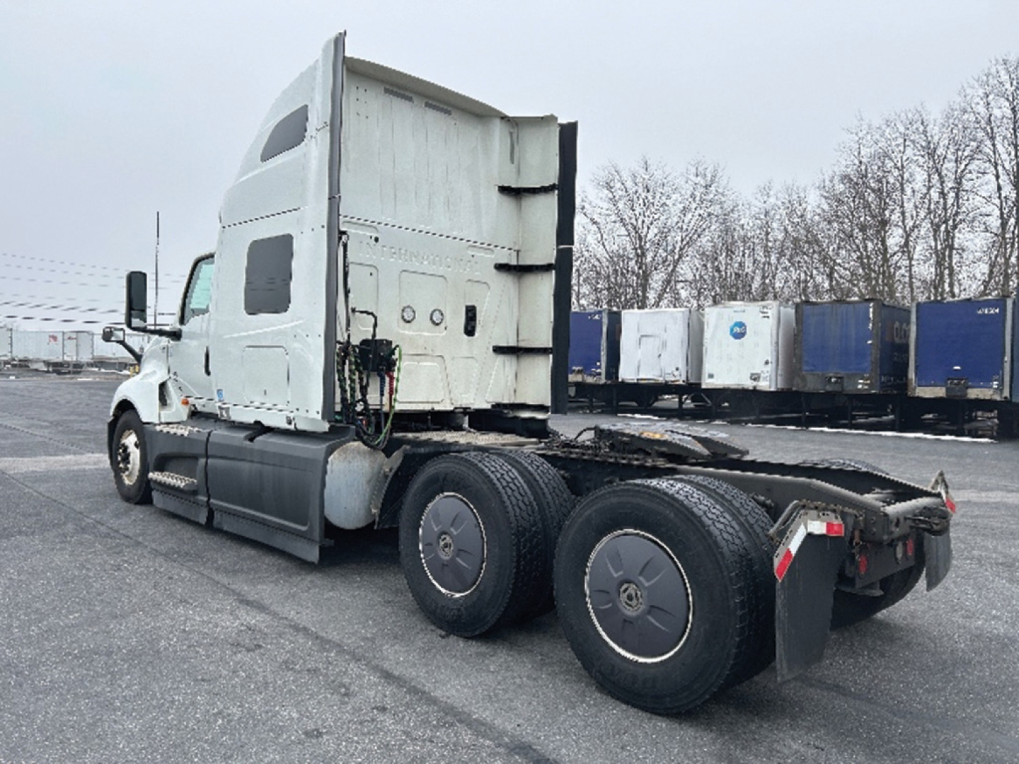 Truck tractor 2023 International LT625 side view showing sleeper cab and rear axles with dual rear wheels and fifth-wheel area.