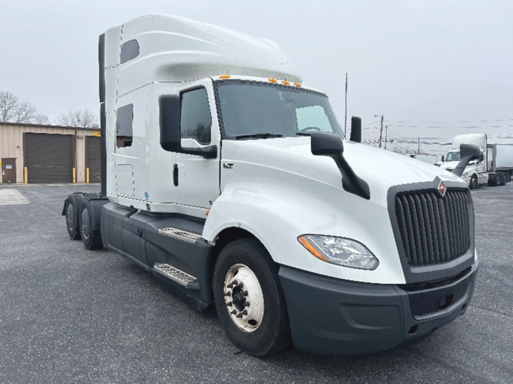 Truck front and side view with cab over engine, International LT625 sleeper tractor. Visible text not legible except general truck shape.