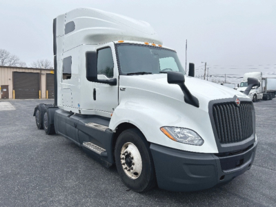 Truck front and side view with cab over engine, International LT625 sleeper tractor. Visible text not legible except general truck shape.