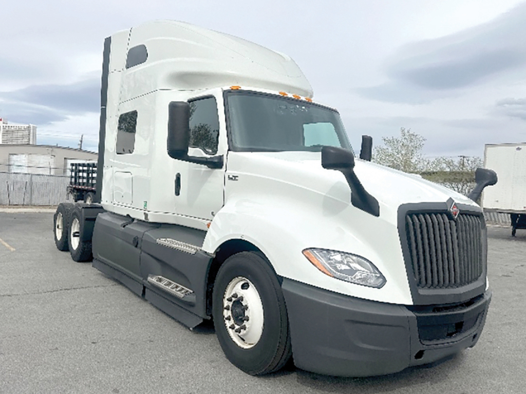 Truck image: 2023 International LT625 conventional sleeper tractor with white cab, black grille, and sleeper cab. Visible text includes no legible stickers; generic truck features and stock details.