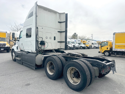 International LT625 truck cab and rear wheel area side view showing sleeper cab and dual rear axles.