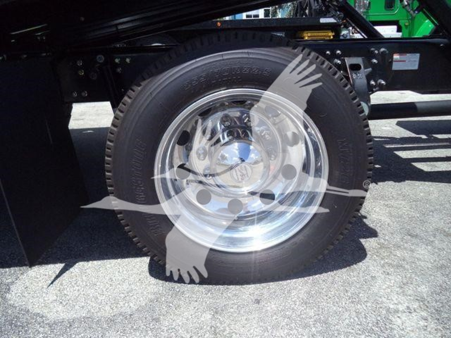 Wheel and tire assembly of a new 2026 Hino L6 rollback truck showing chrome wheel and tire with tire treads visible.