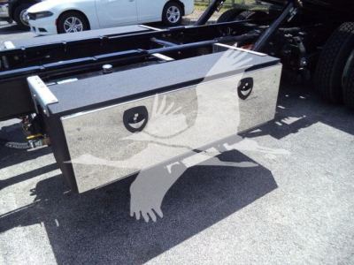 Service body toolbox with two side access doors mounted on truck chassis showing polished metal surface and reflection.