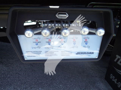Rear control panel of a JERR-DAN rollback body showing five indicator lights and levers for tow operations, with brand name on panel.
