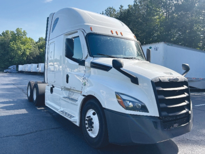 Freightliner Cascadia126 tractor cab side-front view with sleeper, white exterior, black front grille, dual rear axles visible