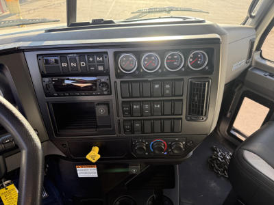 Dashboard of a 2026 Mack GR64F dump truck showing instrument cluster, climate controls, gear selector, ignition, and various switches.