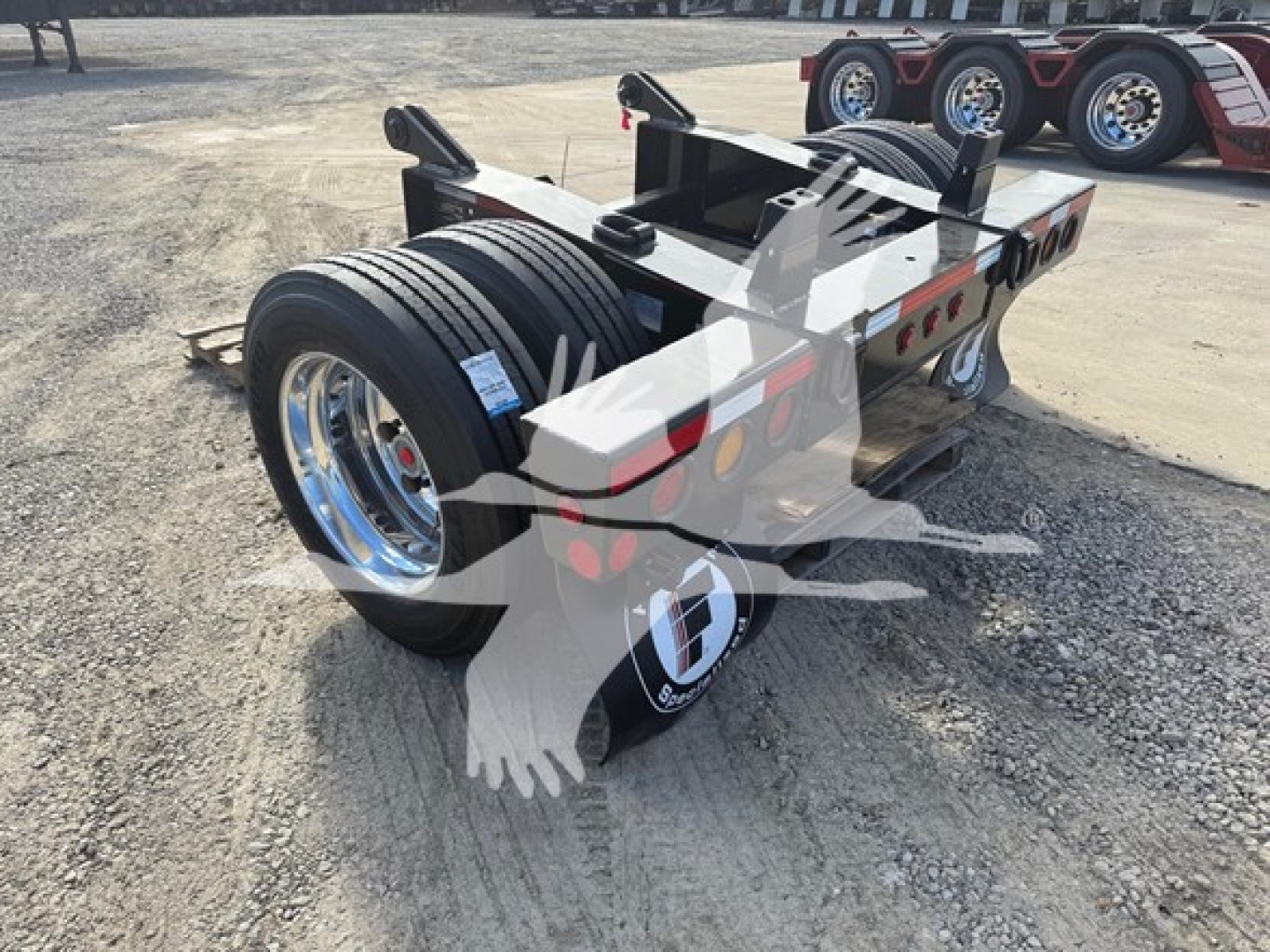 Fontaine flip axle trailer showing dual rear axles with heavy-duty tires and chrome wheels.