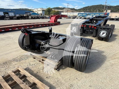 Fontaine flip axle trailer component showing dual tires and wheel hubs with hydraulic lines and frame cross members.