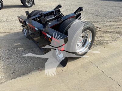 Fontaine flip axle trailer rear view showing dual wheels and hydraulic components with black painted frame.