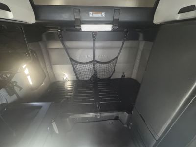Freightliner PT126064ST truck interior cargo area with netted storage and belts visible.