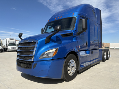 Freightliner PT126064ST semi tractor in blue, front-left view, highway-style sleeper cab with large grille and dual rear wheels.
