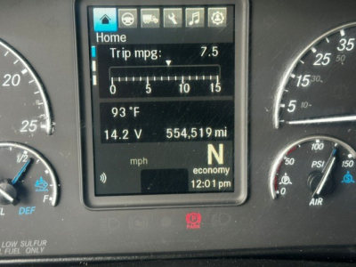 Dashboard cluster of a 2019 Freightliner Cascadia 126 showing digital display with trip mpg 7.5, 14.2 V, 554,519 miles, N gear, 93°F, time 12:01 pm.