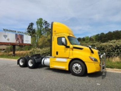 Yellow Freightliner Cascadia 126 daycab tractor in profile view with registration details visible in listing.