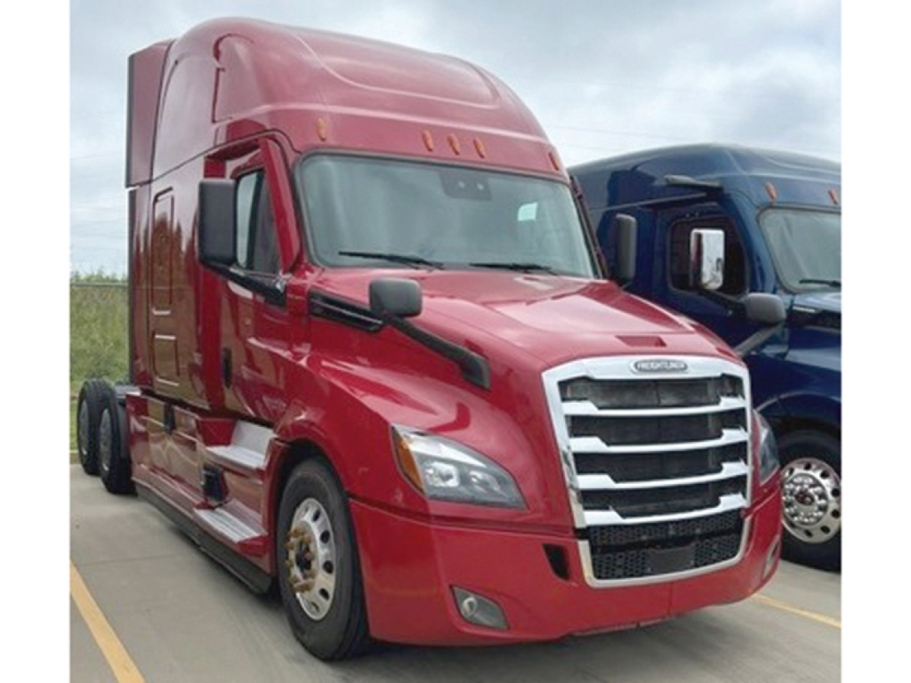 Truck cab showing Freightliner Cascadia126 front view with red color and chrome grille.
