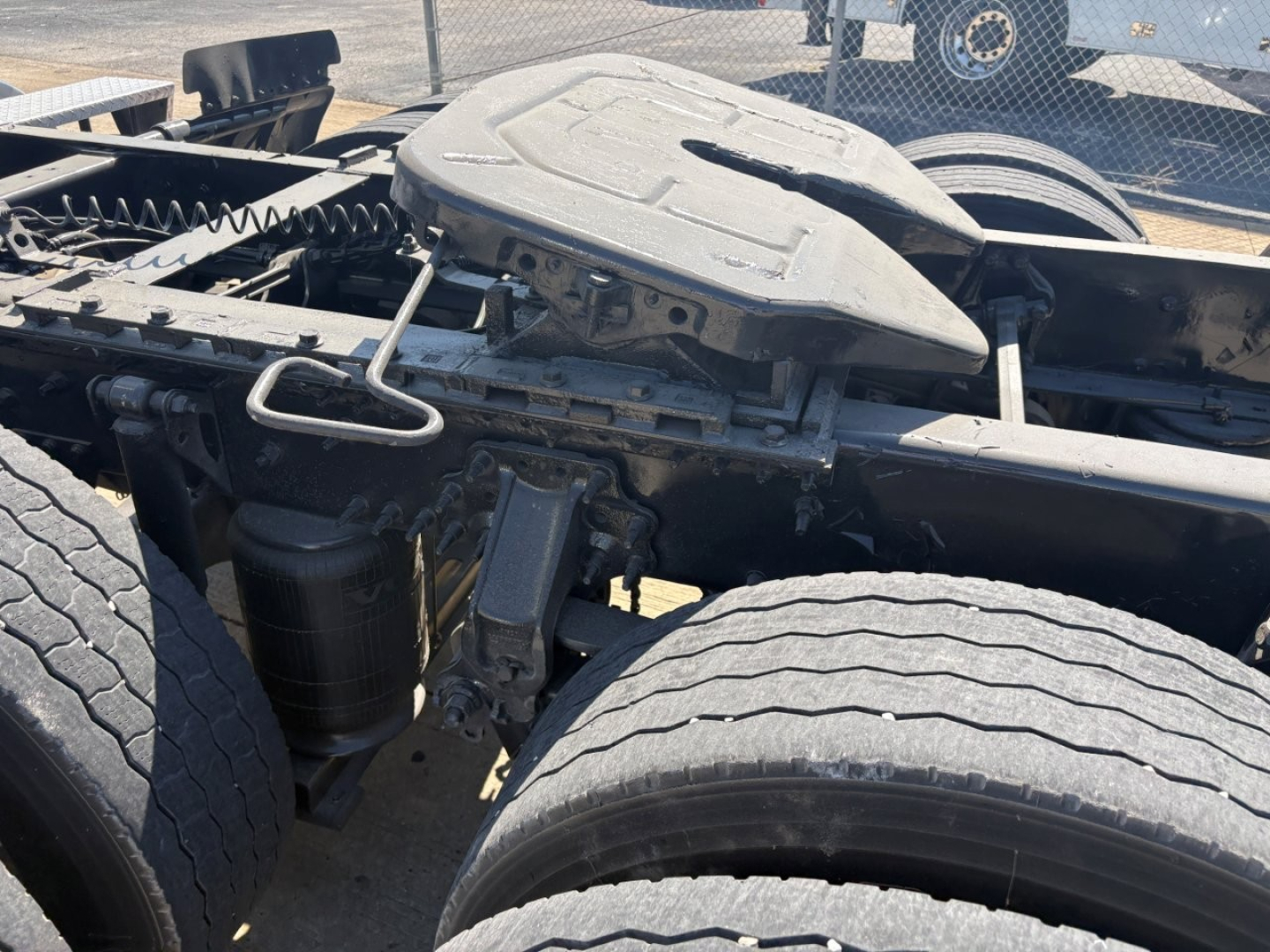 Volvo VNR truck tractor 2024 chassis with fifth wheel and air tanks showing mid-section, dual rear axles, and ride-height suspension components.