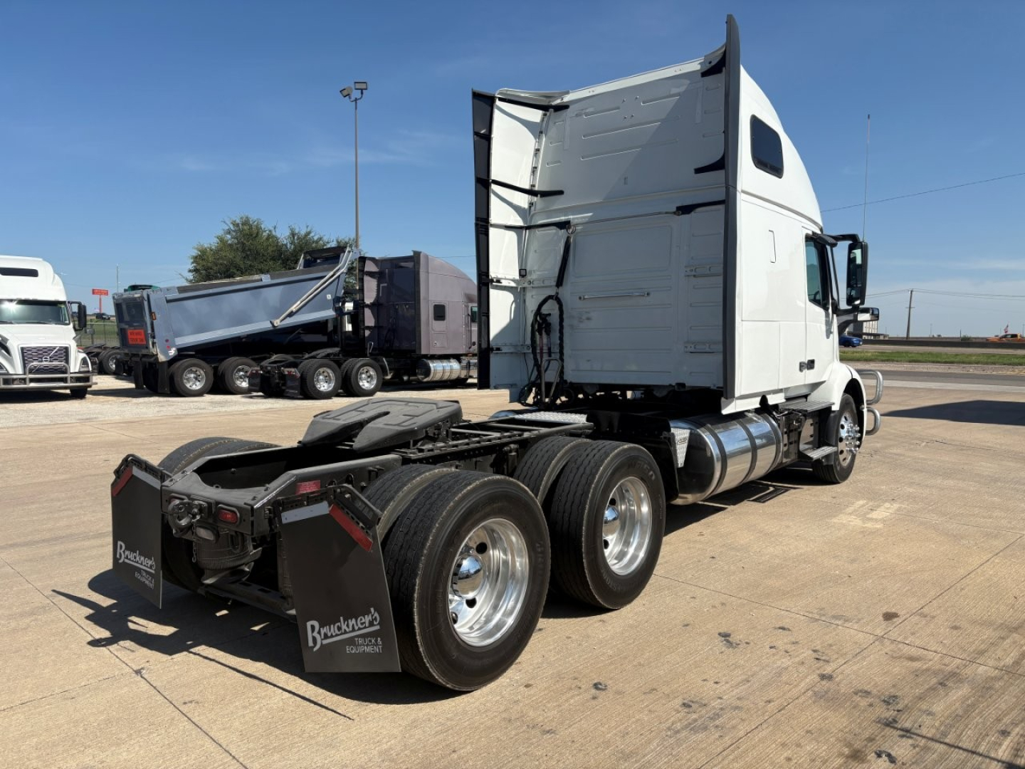 Volvo VNR64T660 truck in-view showing sleeper cab and rear dual-axle configuration with fifth-wheel hitch and large tires.