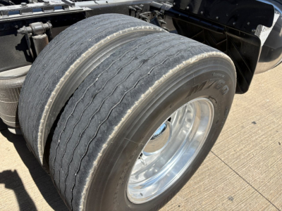 Volvo VNR truck rear dual tires and chrome wheel showing worn tread and sidewall details