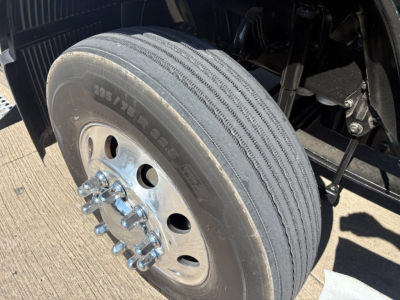 Volvo truck front left wheel showing 295/75R22.5 tire with dual hub and lug nuts visible.