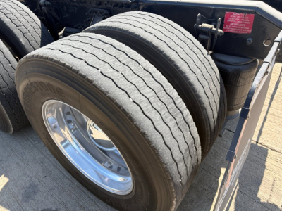 Volvo VNR64T660 truck rear dual tire assembly and fender area showing tandem axles and chrome wheel rims.
