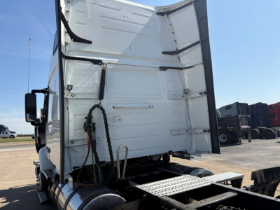 Volvo VNR truck rear section with open cargo area showing interior walls and coupling area, white metal panels, external steps, and chassis components visible.