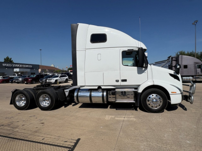 White Volvo VNR64T660 semi-truck tractor in side profile view with sleeper cab, chrome fuel tanks, and dual rear axles.