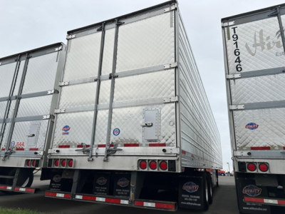 Utility 3000R trailer rear view showing metal panel doors and taillights with reflective tape