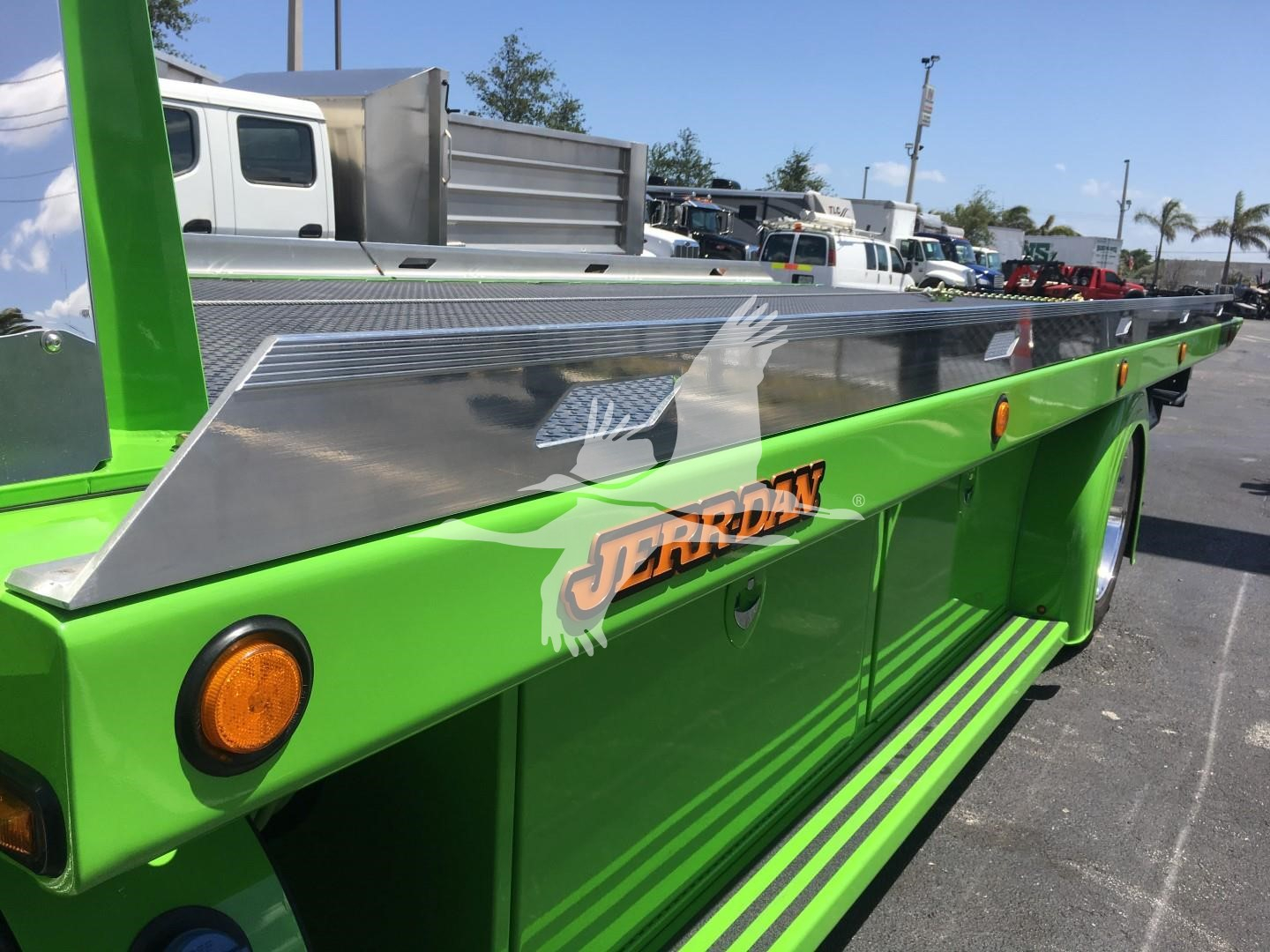 Green Peterbilt rollback truck side with silver guard and JERRDAN logo