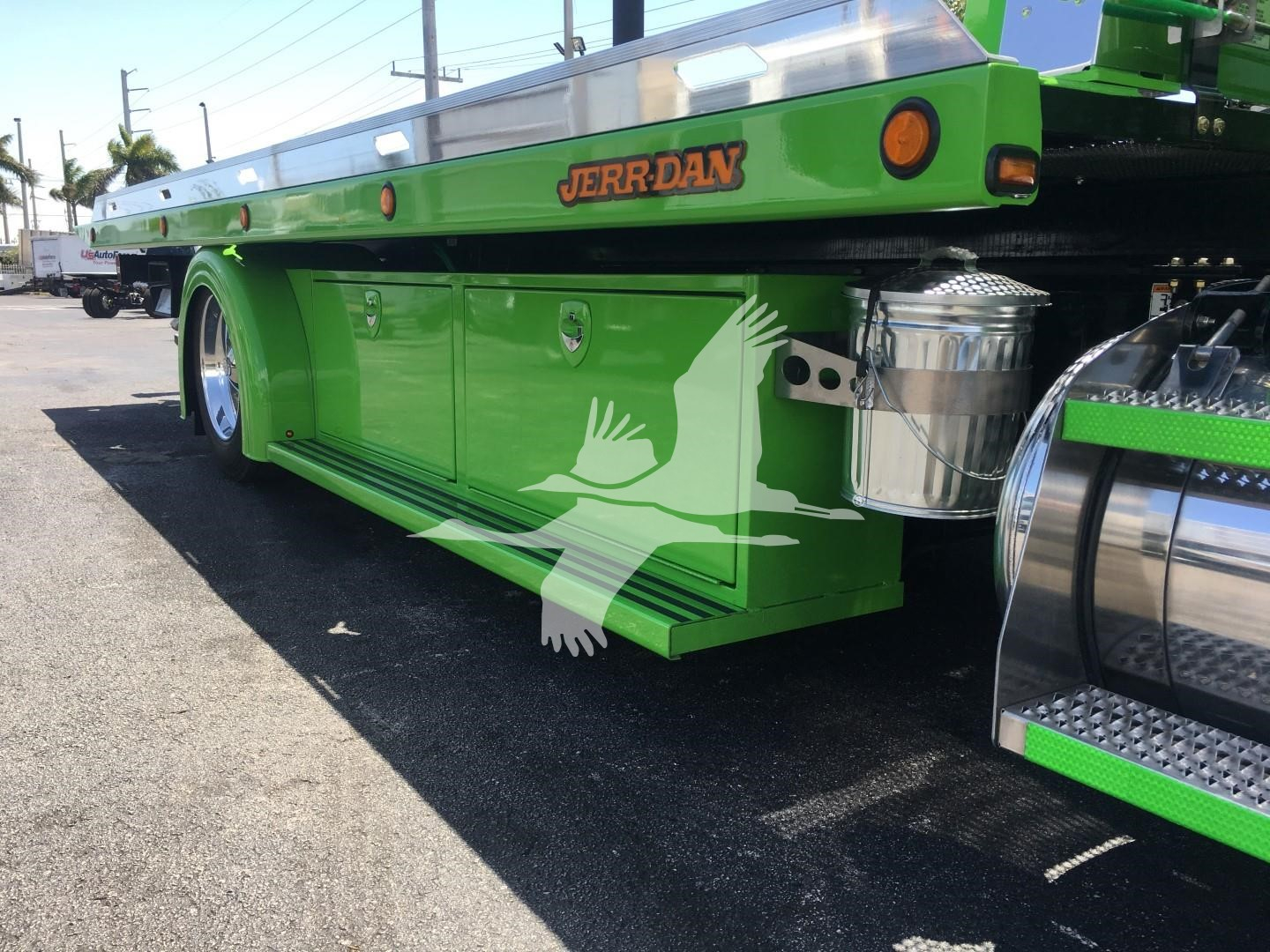 Green Peterbilt rollback truck side view showing storage compartments and JERR-DAV branding.