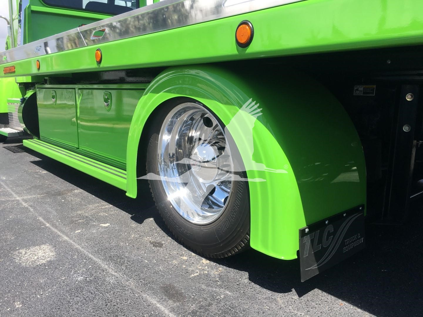 Green Peterbilt 337 rollback truck side and front wheel well with polished chrome wheel and lime green fender.