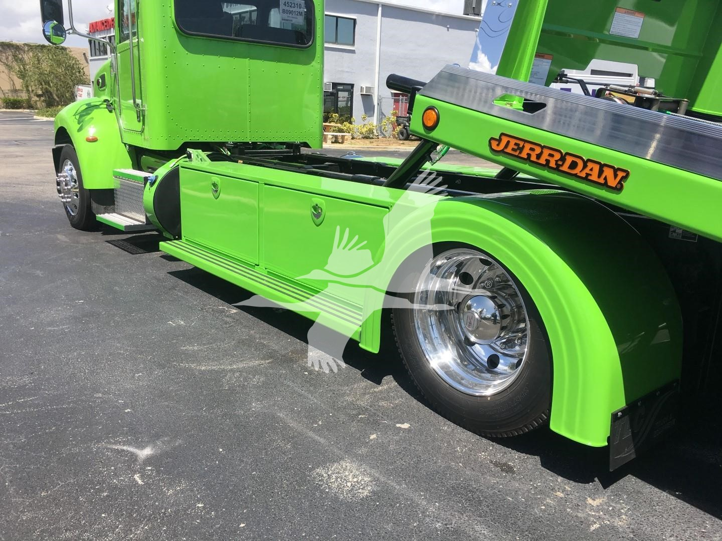 Peterbilt 337 rollback truck in lime green showing rear wheel and JERR-DAN tow equipment with chrome wheel and body text