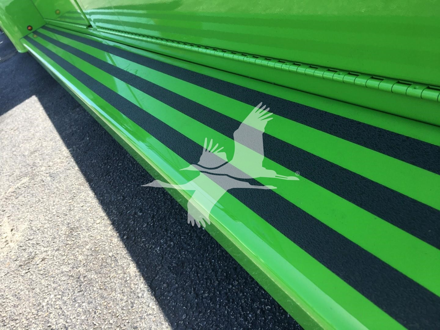 Green Peterbilt 337 rollback truck side panel with black stripes, close-up view of lower side rail and body; stock number J52310 listed.