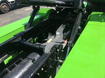 Peterbilt 337 rollback chassis frame section showing hydraulic lift components and green bed