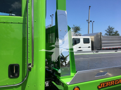 Green Peterbilt 337 truck cab with metal steps and side details visible.