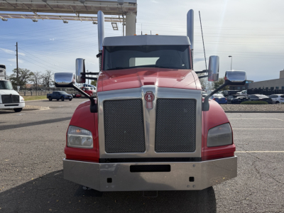 Front view of a red and gray 2020 Kenworth T880 conventional daycab truck, with large chrome grille, tall mirrors, and bumper; VIN and stock info not visible in image.