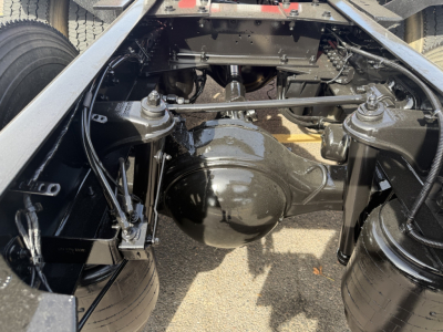 Remainder of Kenworth T880 chassis showing rear axle housing and suspension components in view under cab.