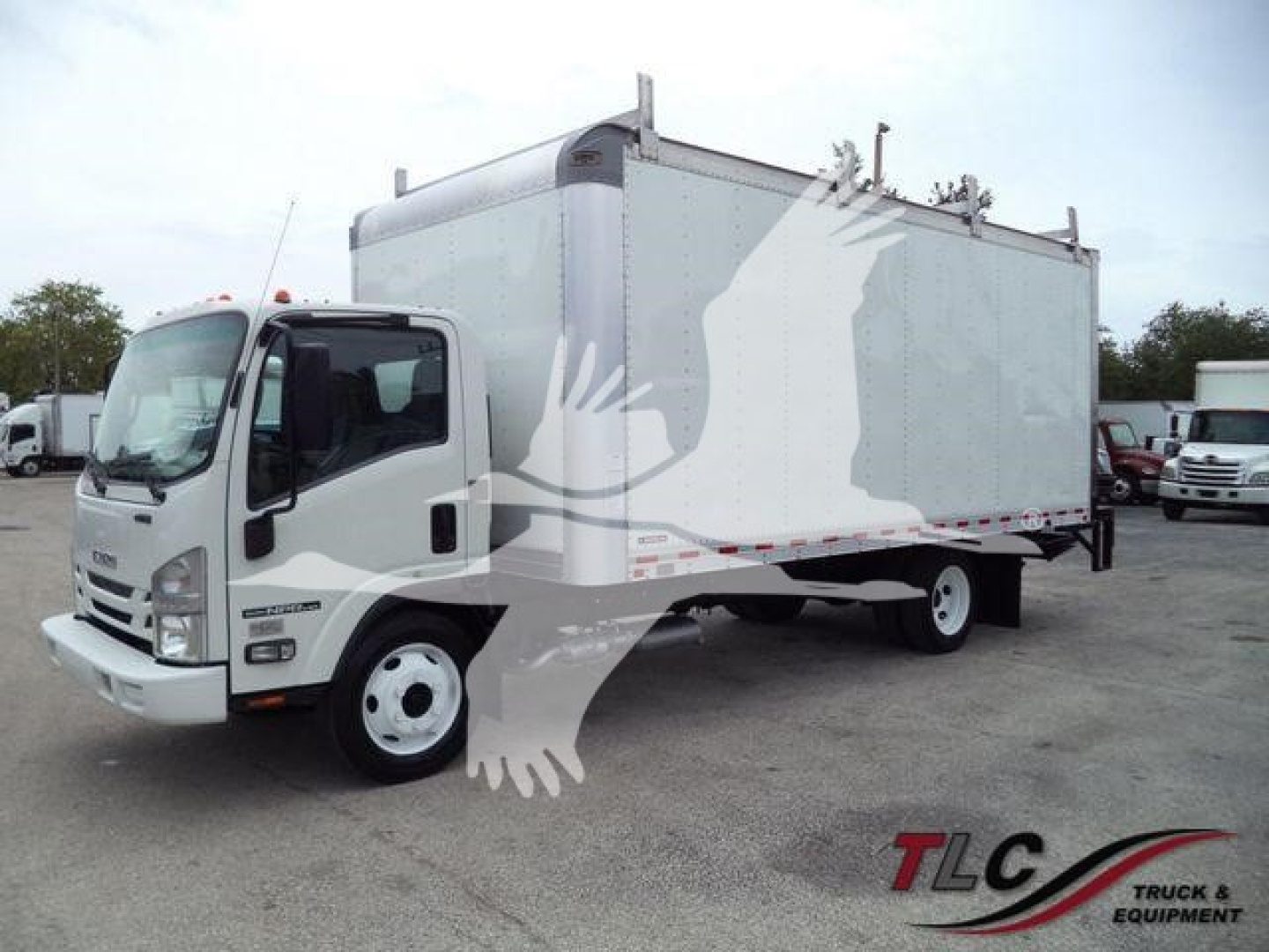Isuzu NPR HD box truck showing cargo box with white and gray paint and side graphic, front cab and dual rear wheels visible.