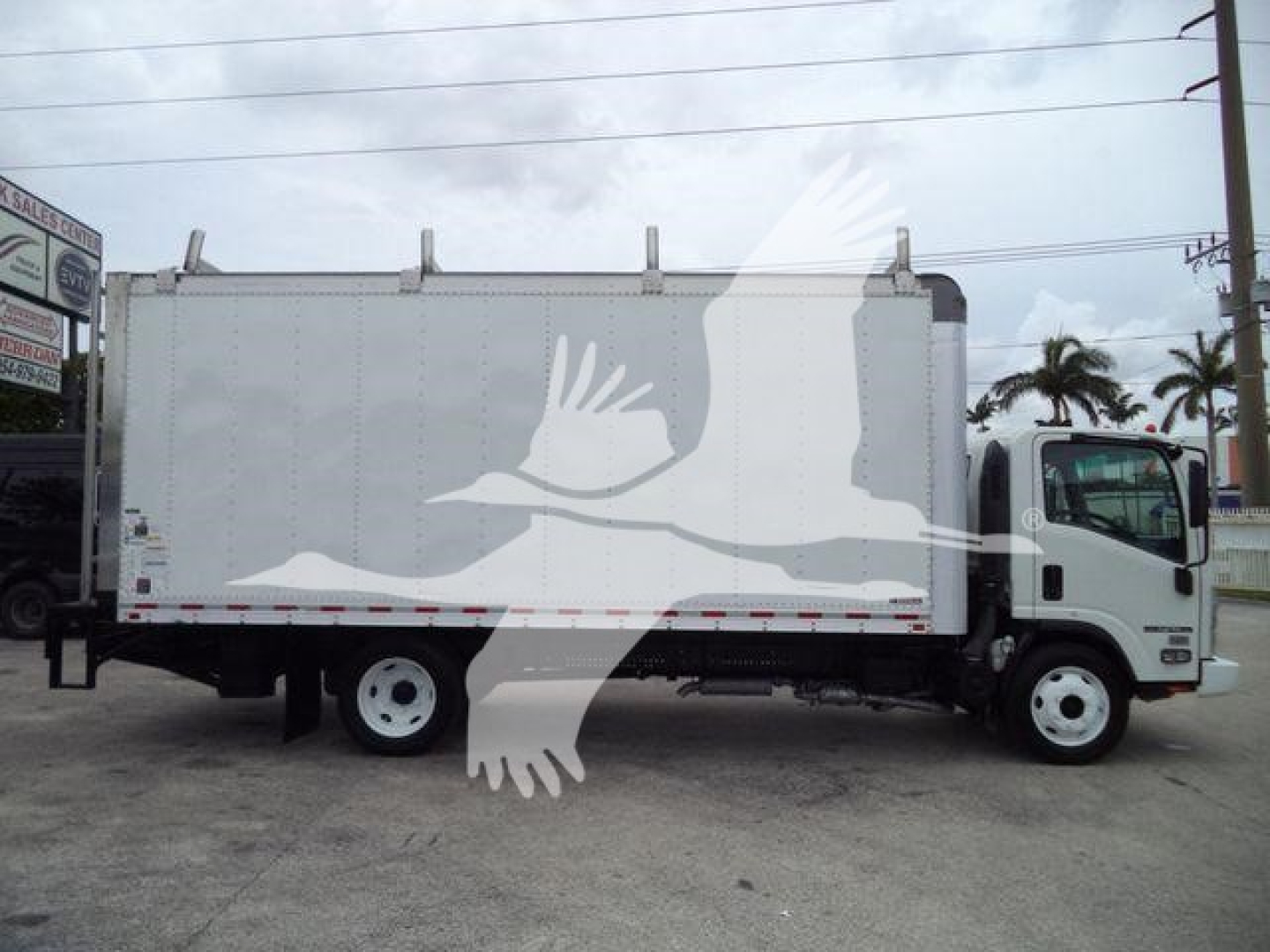 Box truck side view showing Isuzu NPR HD with white cargo box and cab