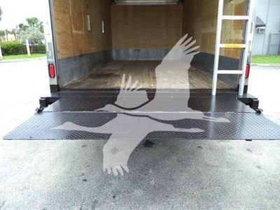 Isuzu NPR HD box truck rear cargo area with fold-down ramp and wooden interior