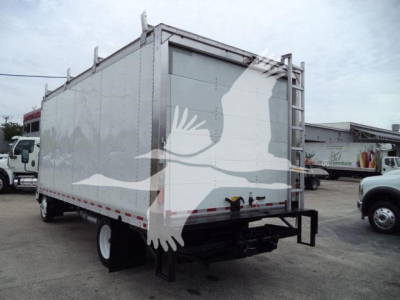 Isuzu NPR-HD box truck rear view showing cargo box with white decorative graphics and rear underrun protection.