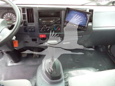 Isuzu NPR-HD cab interior showing dashboard with center console, gear shifter, and mounted tablet display.