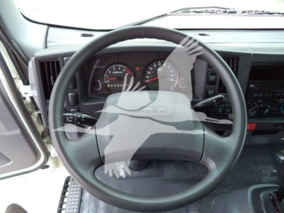 Isuzu NPR HD truck interior showing steering wheel and dashboard gauges.