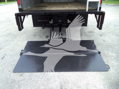 Isuzu NPR-HD truck rear view showing hydraulic lift/ramp extended with diamond plate surface.