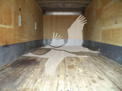 Truck bed interior showing wooden floor and side walls inside a box truck