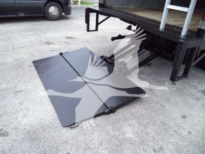 Isuzu NPR HD truck bed with lowered loading ramp and undercarriage visible.