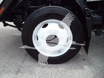 Isuzu NPR HD truck wheel and tire showing front axle with white steel hubcap and black tire.