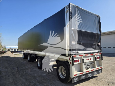 Mac aluminum flatbed trailer showing rear and side with tarp sides and taillights; VIN 5MAPA4842PA067786 and stock 7659 visible.