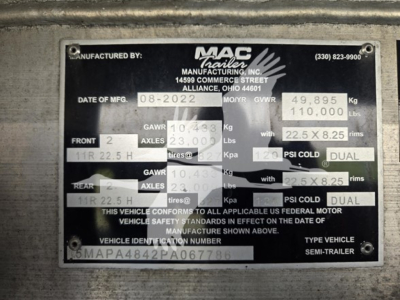 Plate/label showing MAC trailer manufacturing data plate with VIN partial 5MAPA4842PA067786, GVWR 49,895 kg, front/rear axle specs, and tire sizes.