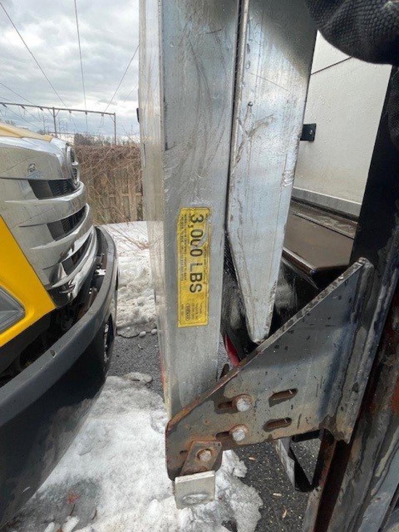 Truck hitch area of a 2016 Hino 268 with a yellow label and metal latch visible in the cargo area.